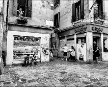 Ladyphone A street scene in Venice with tourists and locals in black and white, street photography.